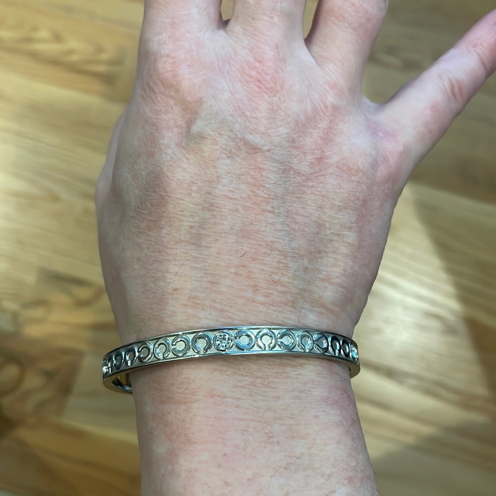 Silver tone Coach signature C bangle bracelet.